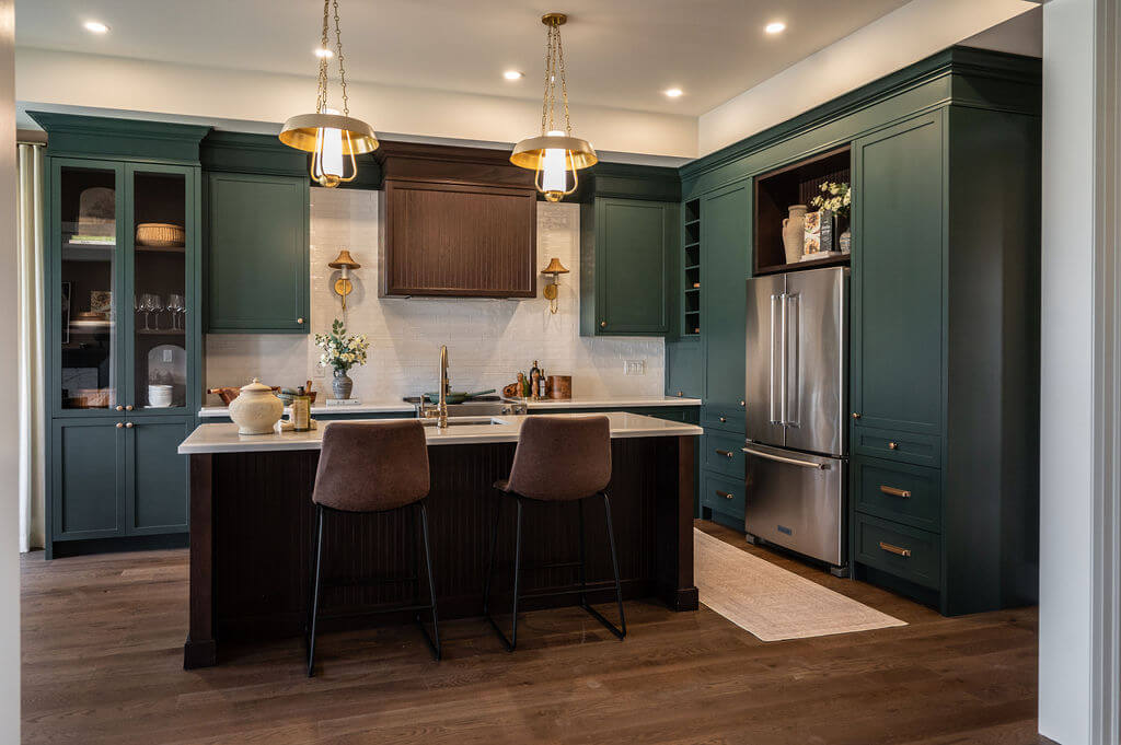 These dark green cabinets create moody atmosphere that pairs well with darker accents.