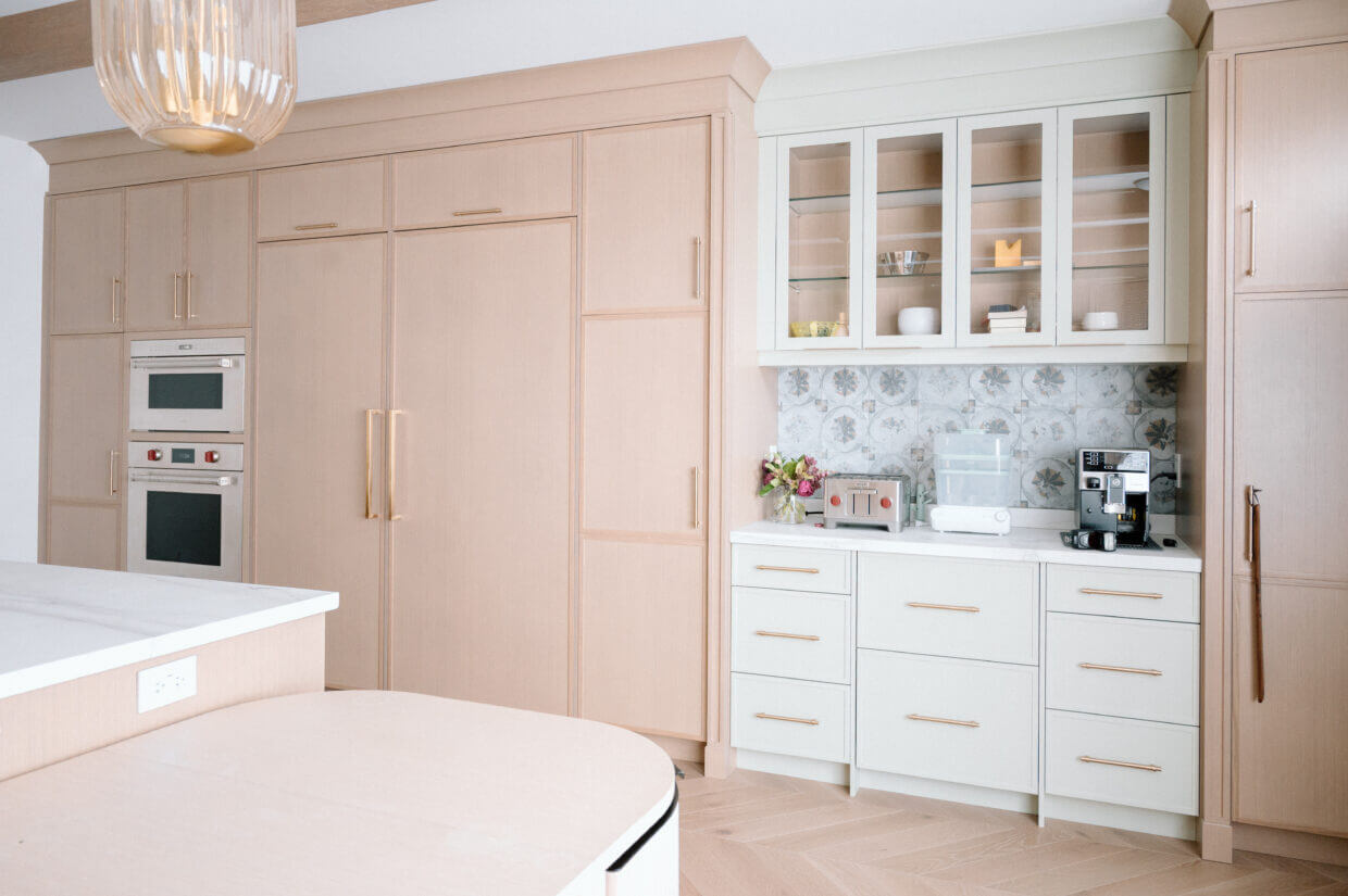 This section of painted cabinets adds a visual break between the stained cabinets.